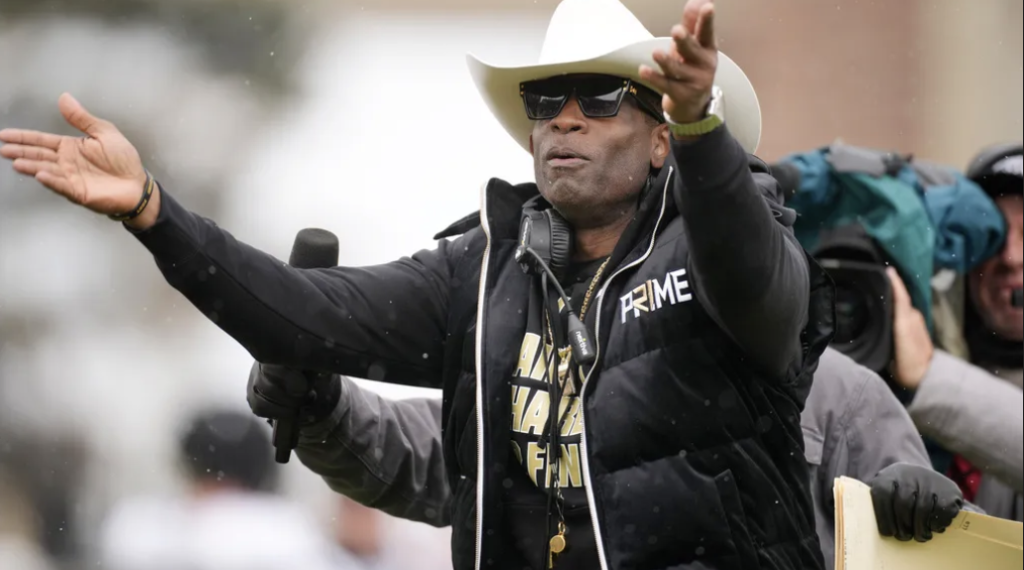 Colorado head coach Deion Sanders plays to the fans in the first half of the team’s spring practice NCAA college football game Saturday, April 22, 2023, in Boulder, Colorado.